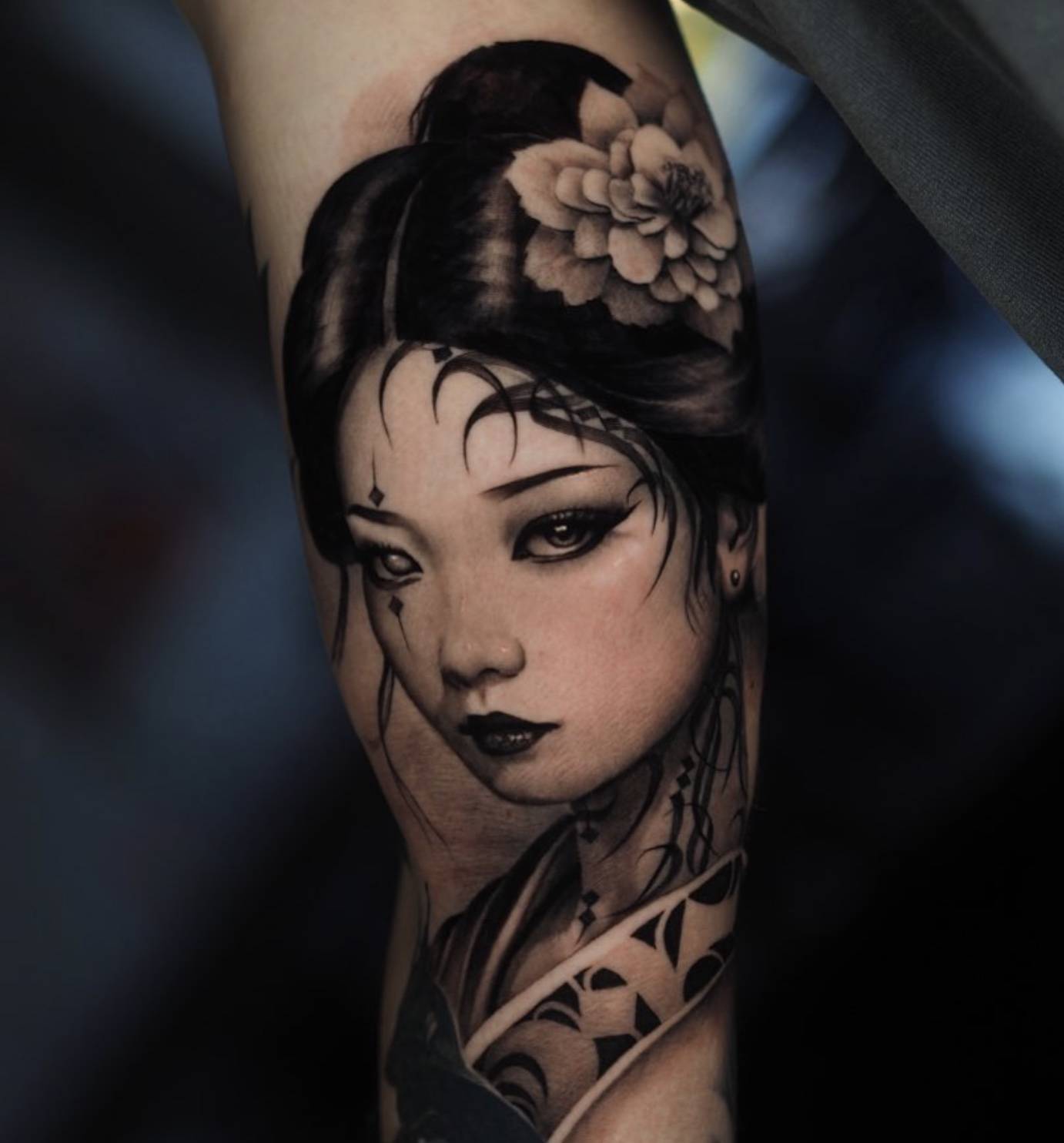 Elegant black and gray portrait of a geisha or Asian-inspired woman with decorative hair ornament